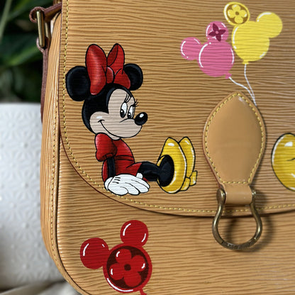 Tan handbag with Minnie Mouse design featuring balloons on a neutral background