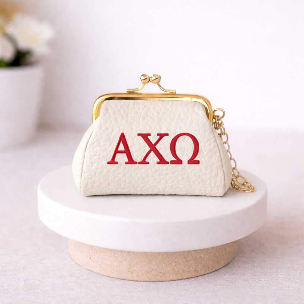 White handbag with red 'AXO' letters on a white surface