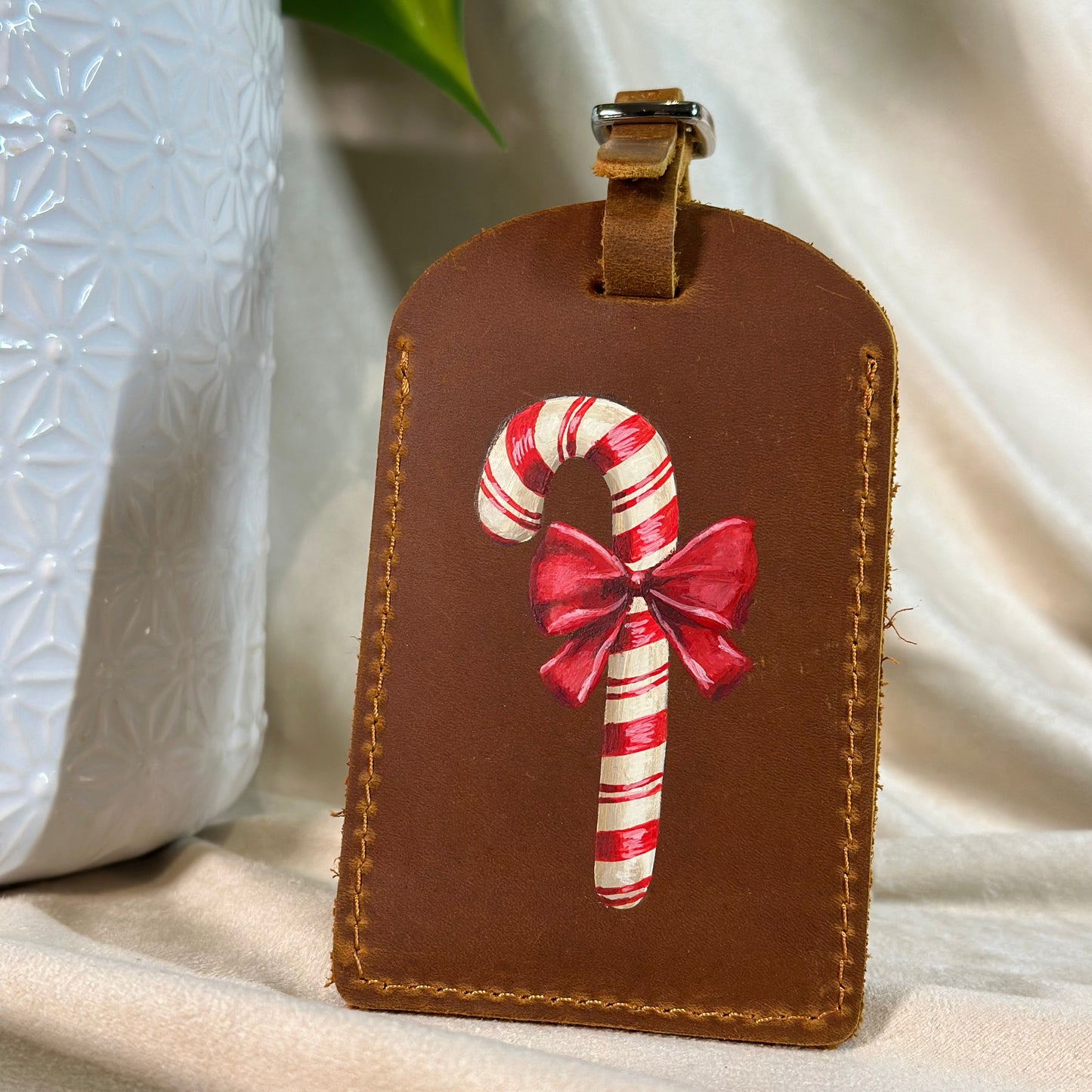 Luggage tag with a hand painted candy cane