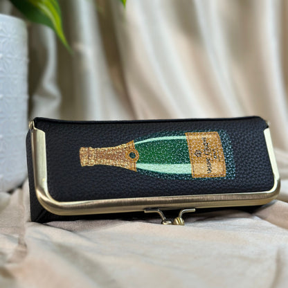 Phone case with champagne bottle design on a soft surface