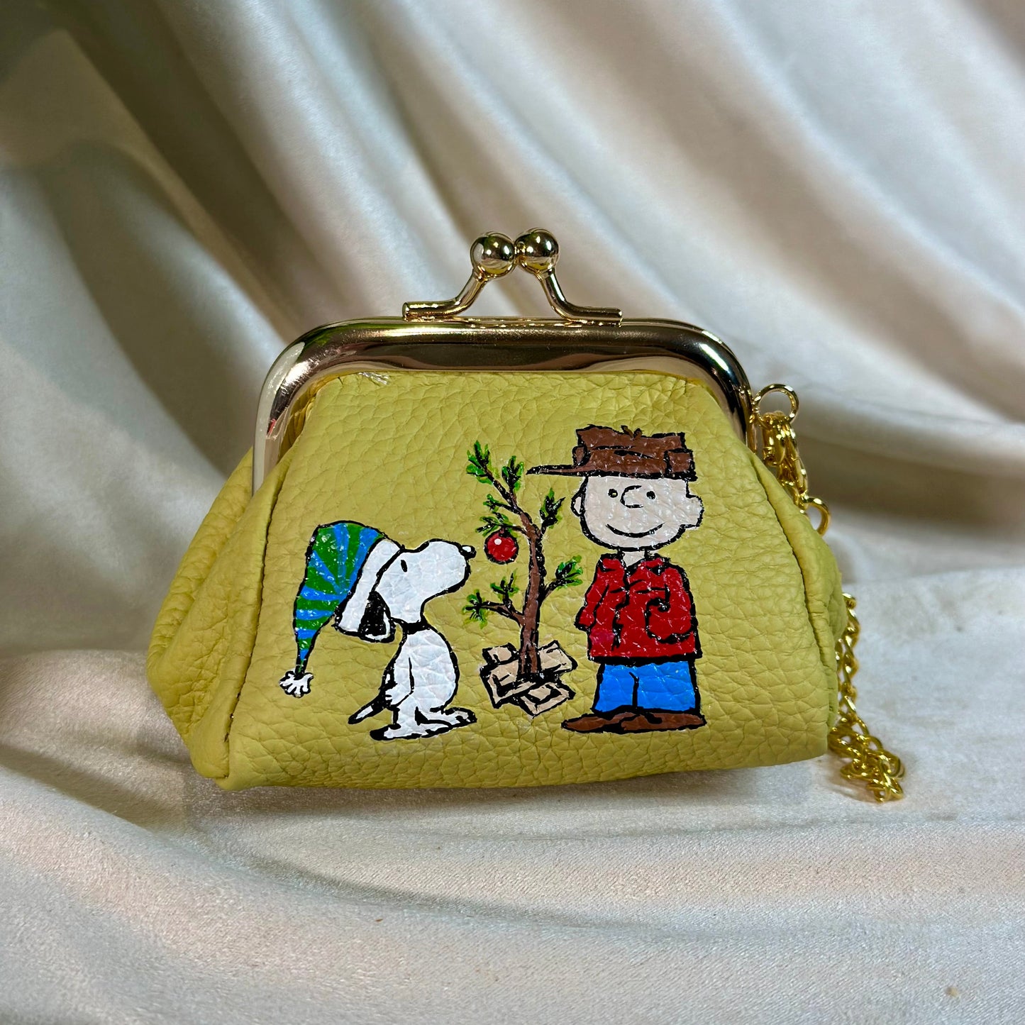 Charlie Brown and Snoopy painted onto a leather change purse