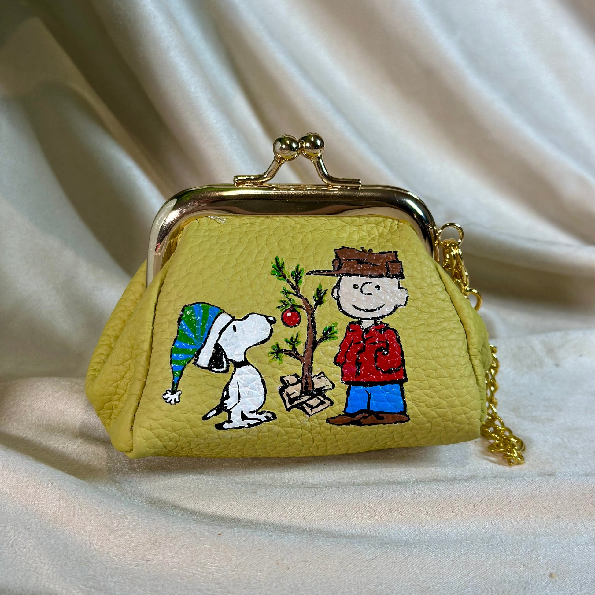 Charlie Brown and Snoopy painted onto a leather change purse