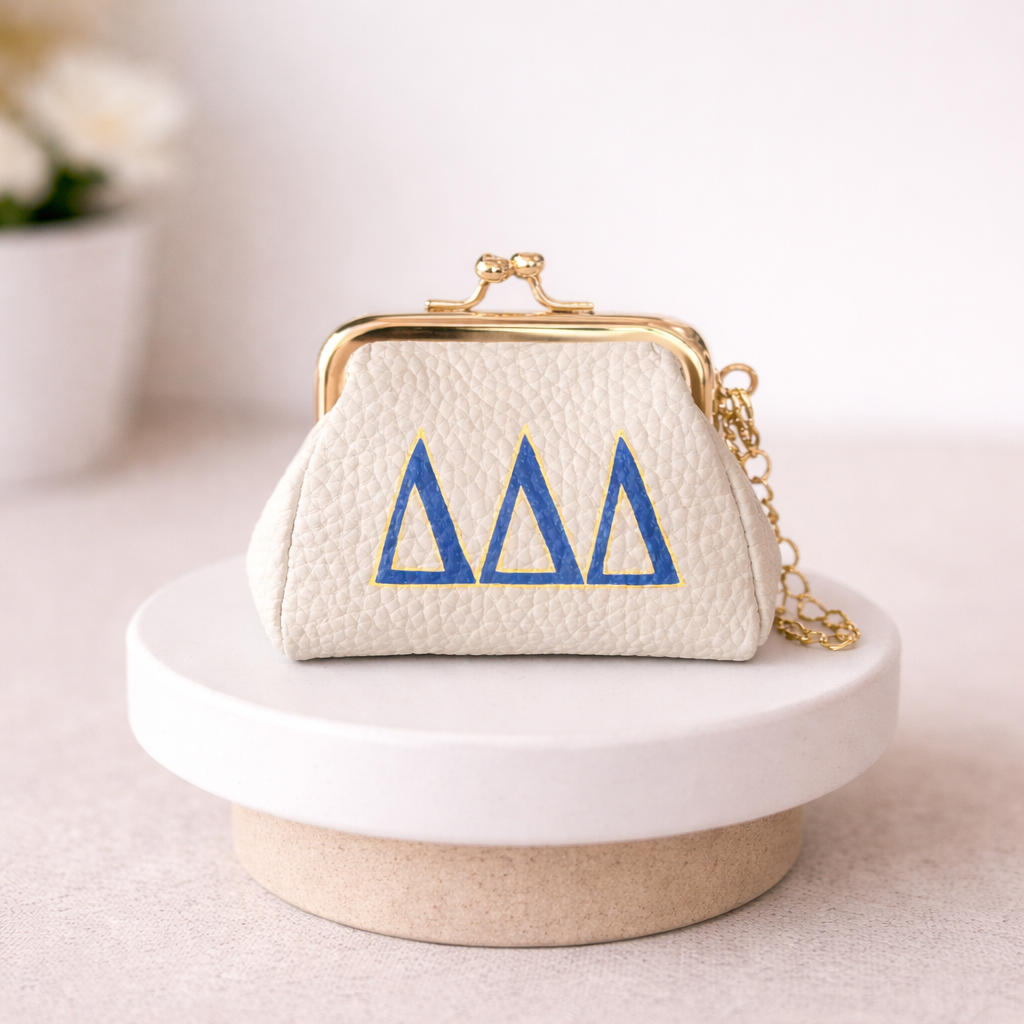 Small white purse with blue symbols on a white surface