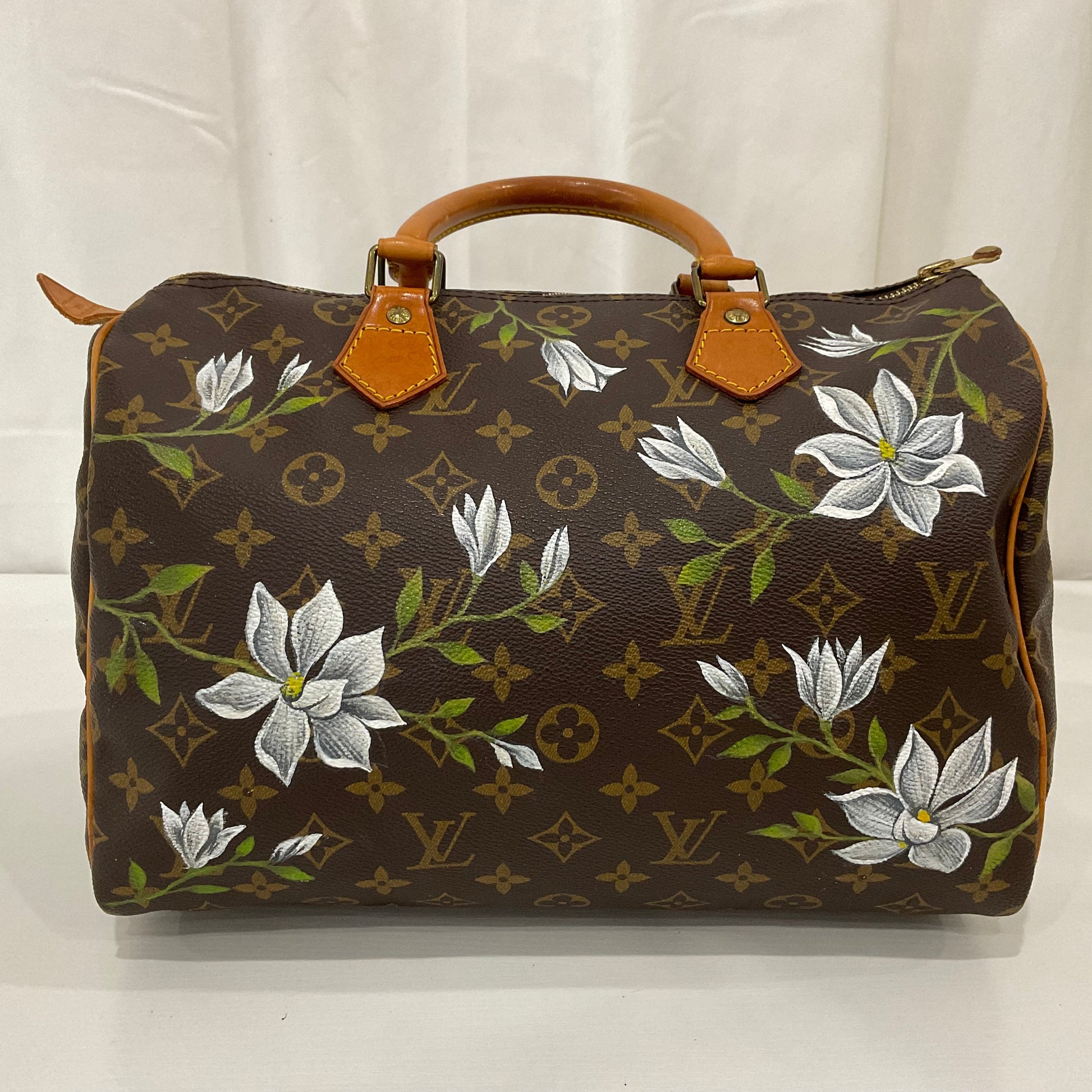 Designer handbag with floral patterns on a white background