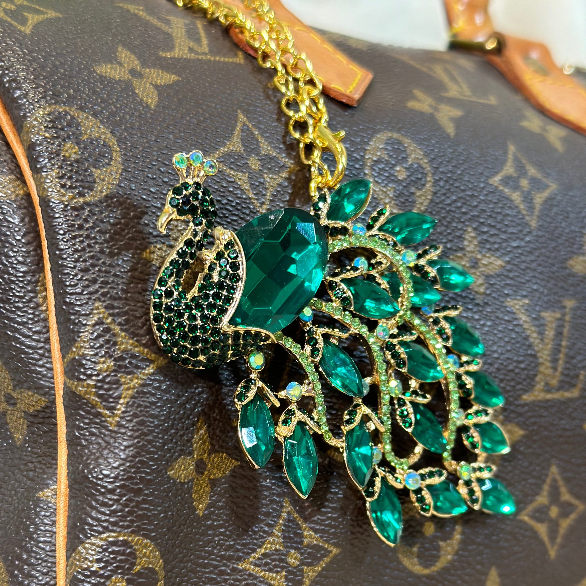 Green and gold brooch on a patterned surface