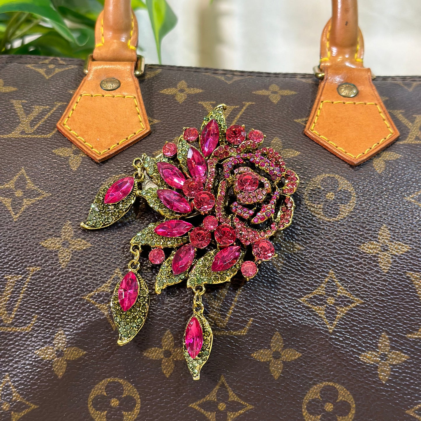 Decorative brooch on a Louis Vuitton handbag