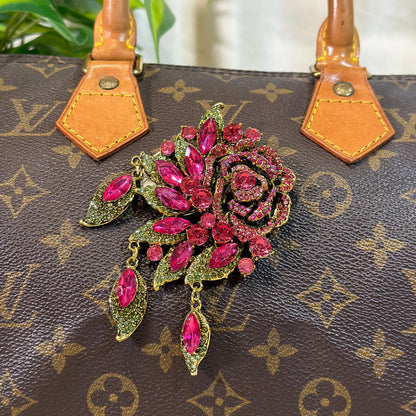 Decorative brooch on a Louis Vuitton handbag
