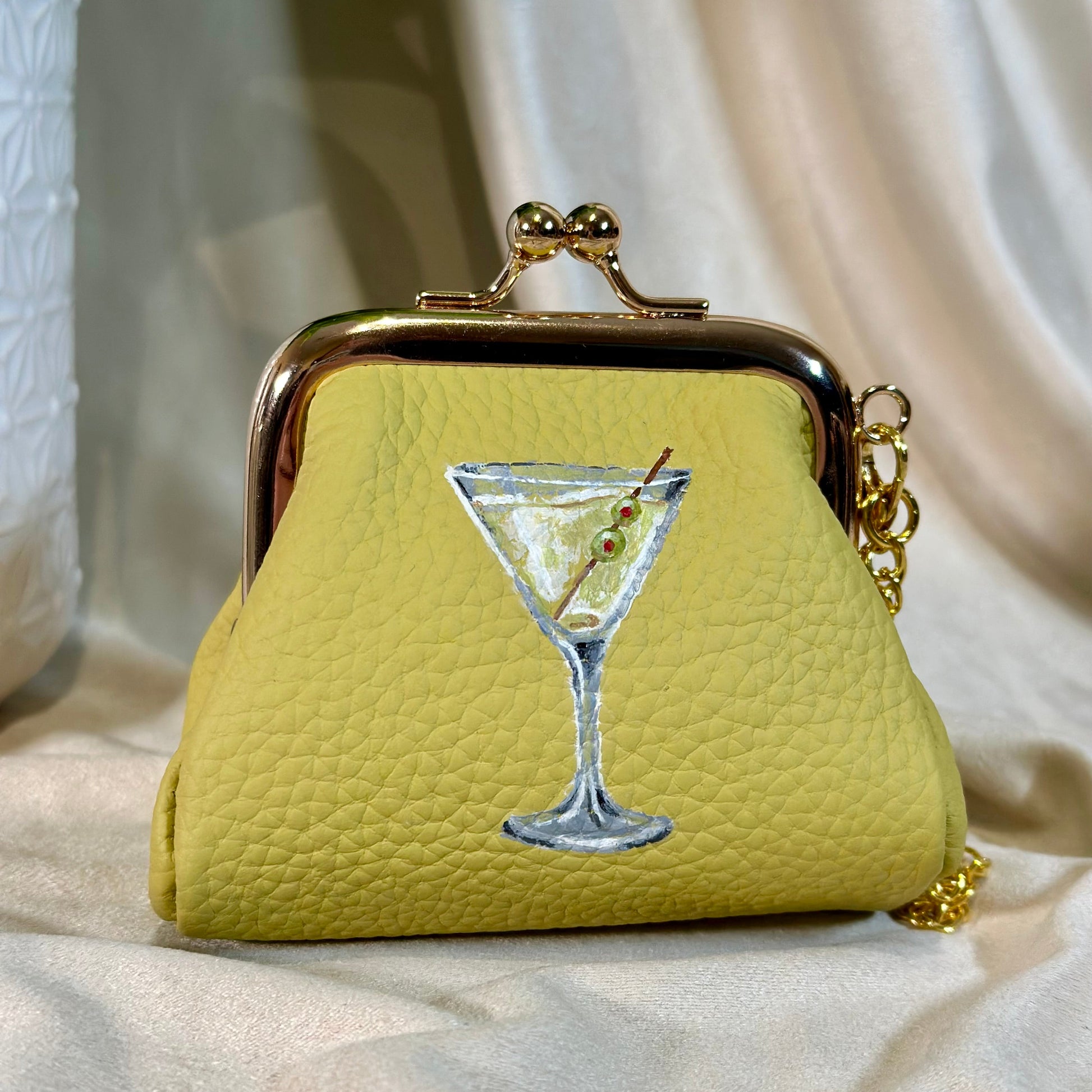 Yellow purse with a martini glass design on a light background
