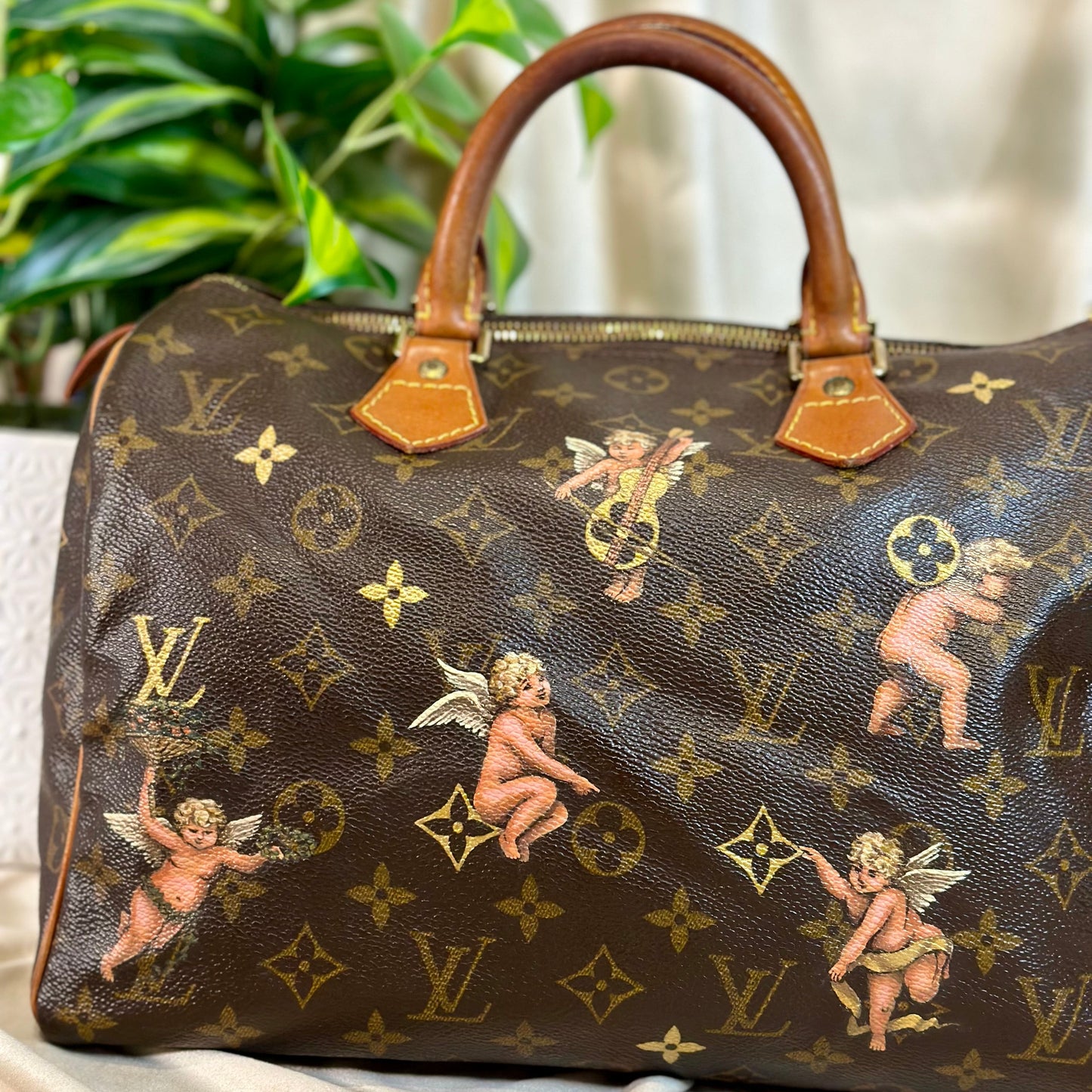 Designer handbag with cherub pattern on a marble surface
