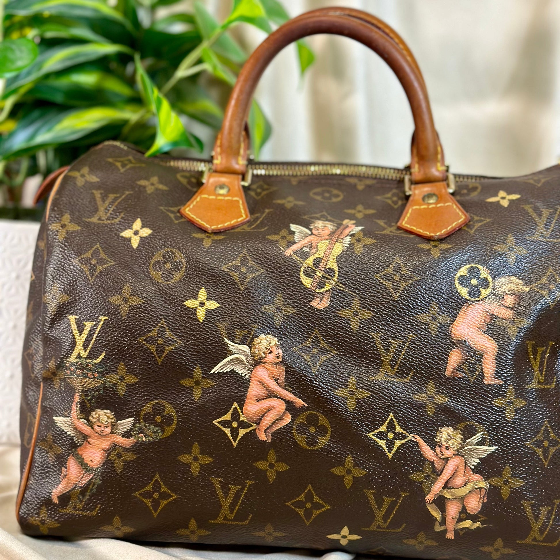 Designer handbag with cherub pattern on a marble surface