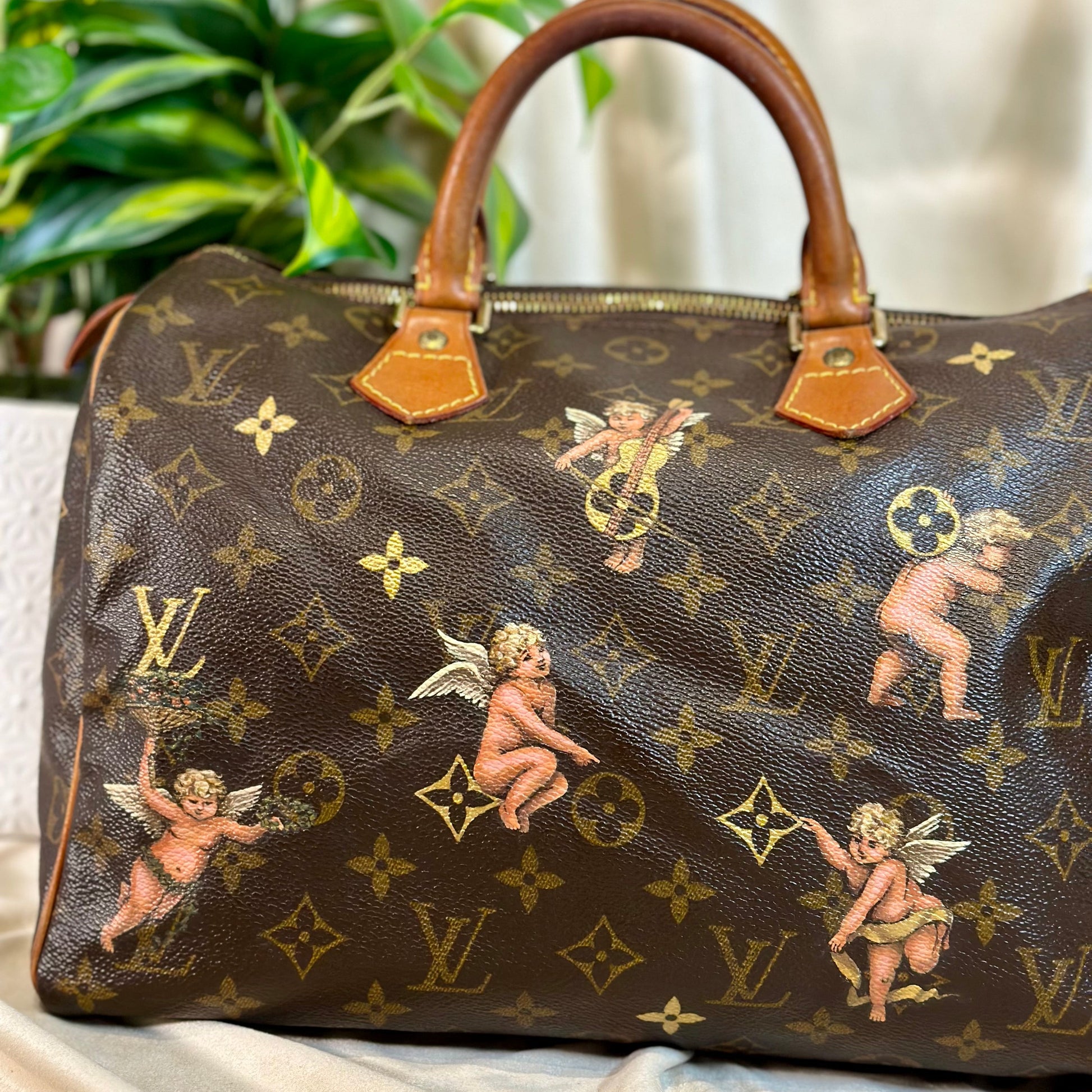 Designer handbag with cherub pattern on a marble surface