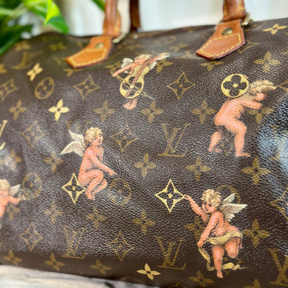 Designer handbag with cherub and monogram pattern on a neutral background