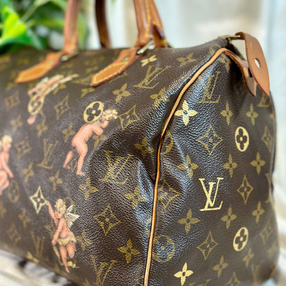 Designer handbag with monogram pattern on a neutral background