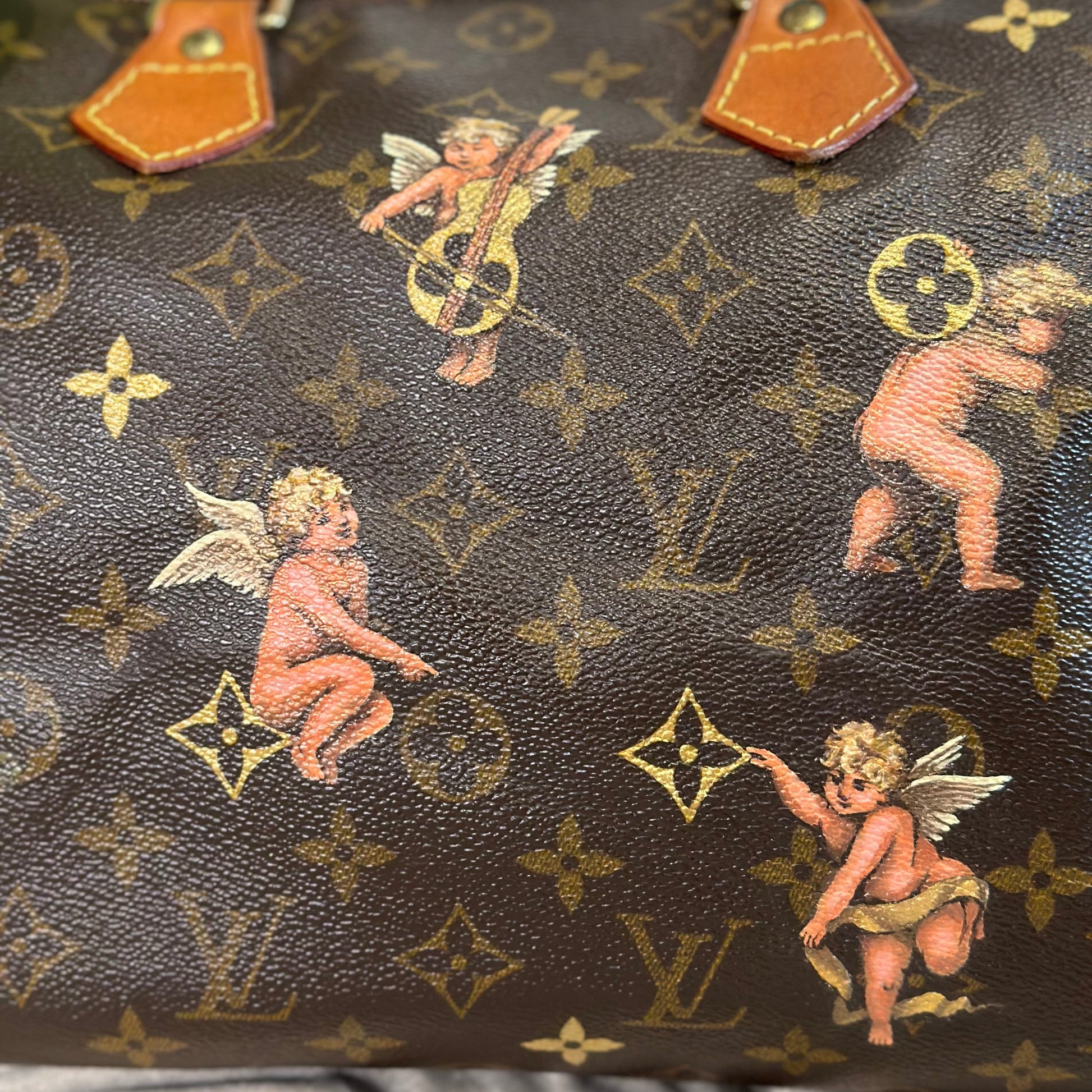 Designer handbag with cherub pattern and monogram design