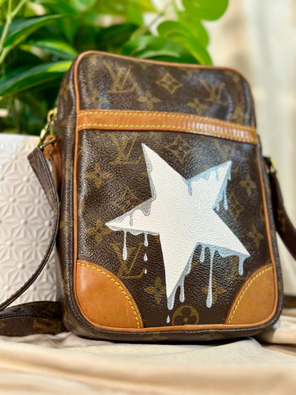 Designer handbag with a star design on a neutral background