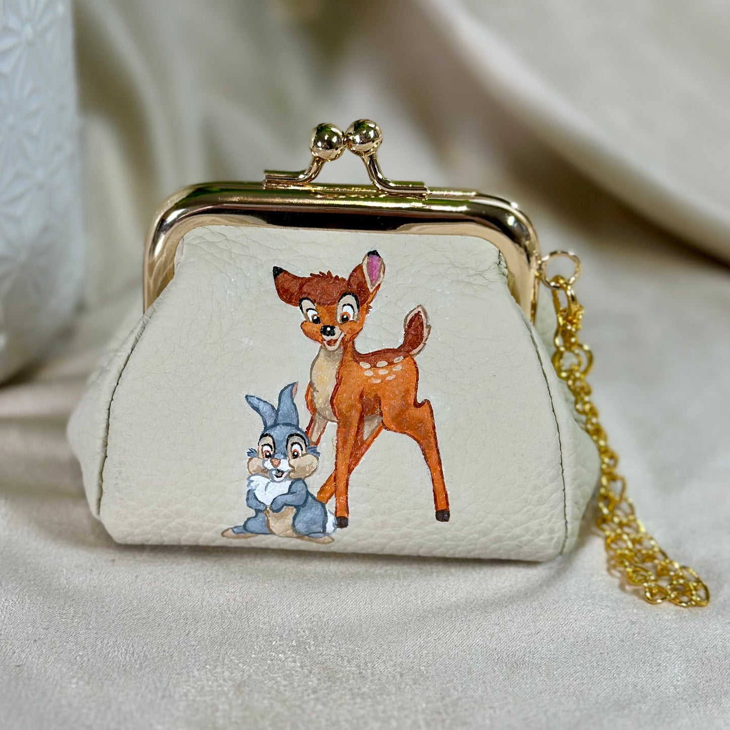 Small purse with cartoon characters on a beige background