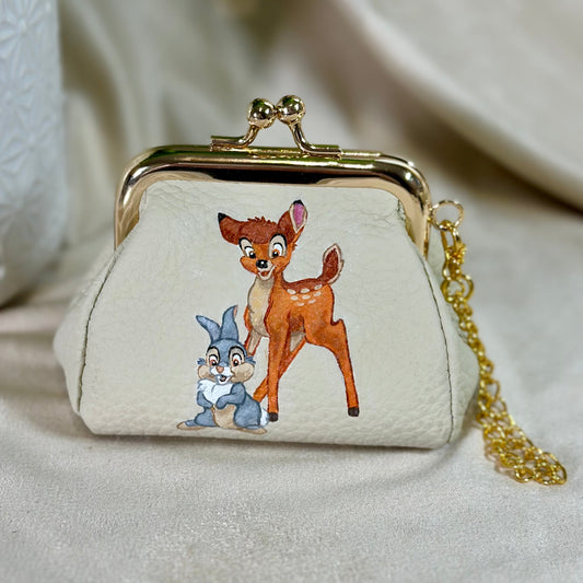 Small purse with cartoon characters on a beige background