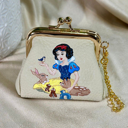 Small purse with Snow White design on a beige background