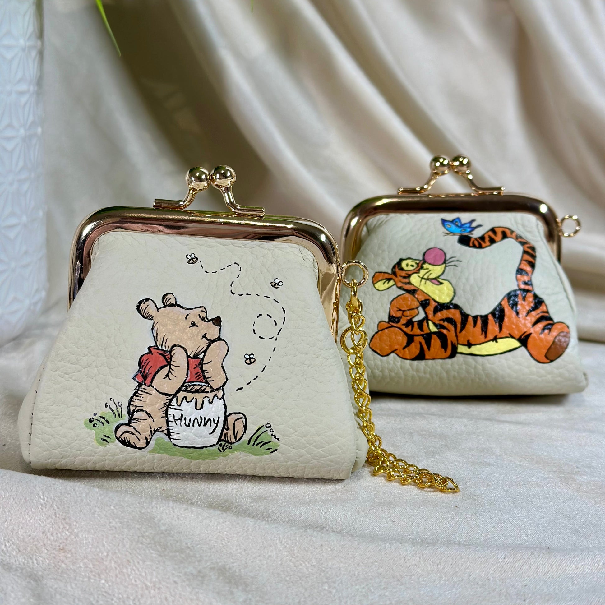 Two small pouches with cartoon characters on a white fabric background