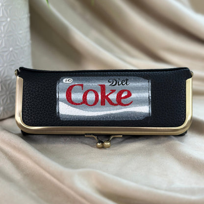 Belt bag with Diet Coke logo on a beige fabric background