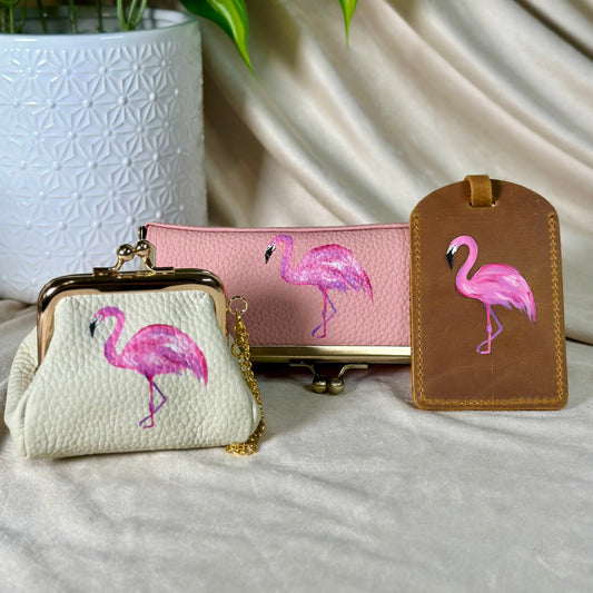 Flamingo-themed accessories including a small bag, pouch, and luggage tag on a neutral background.
