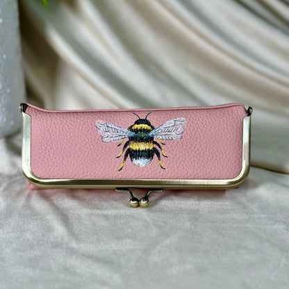 Pink case with bee design on a light background