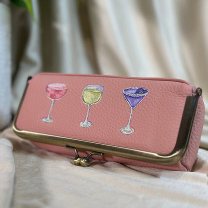 Pink wallet with wine glass illustrations on a light background