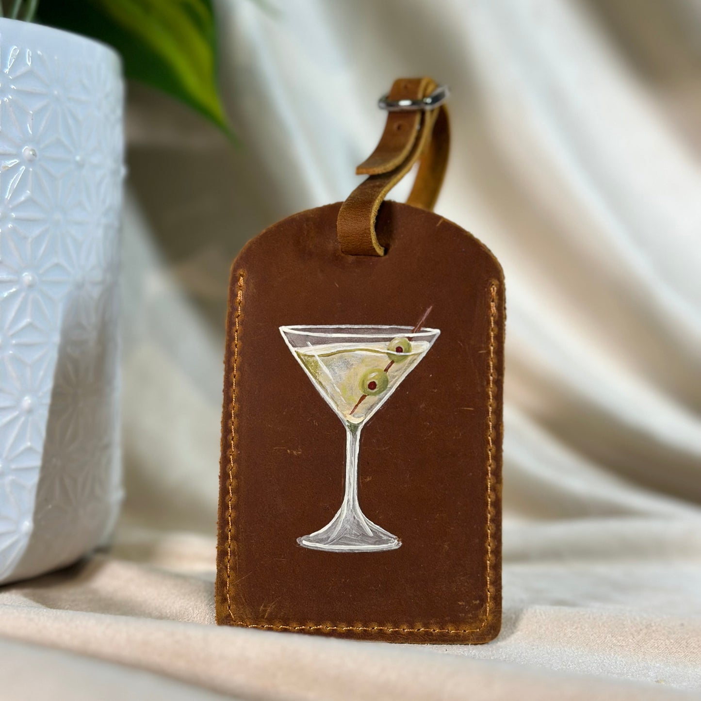 Brown luggage tag painted with a martini