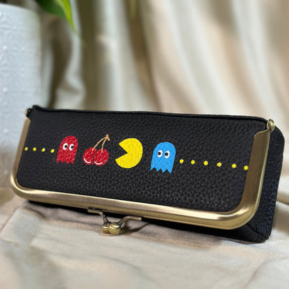 Black pouch with colorful character designs on a light background