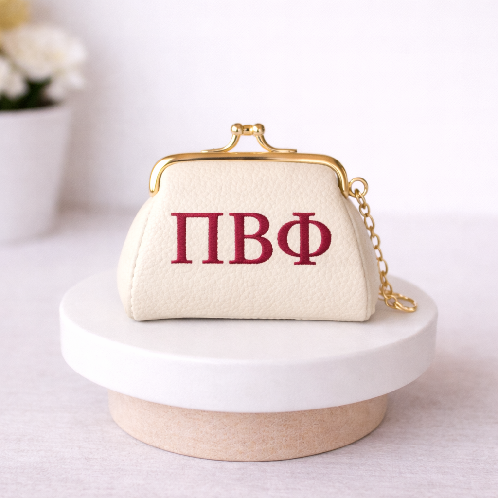 Small cream-colored bag with red letters on a white surface