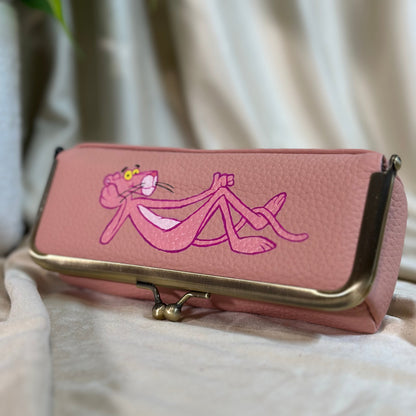 Pink wallet with a character design on a light background