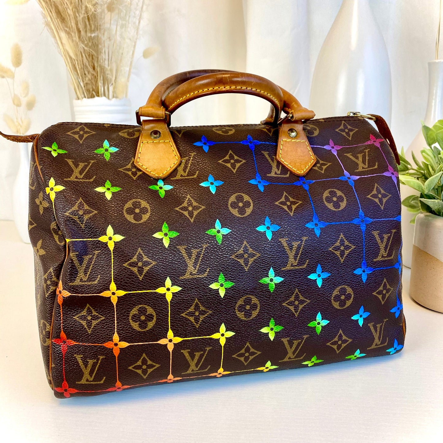 Designer handbag with multicolor pattern on a white surface